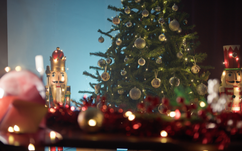 Woman admiring Christmas tree outdoors